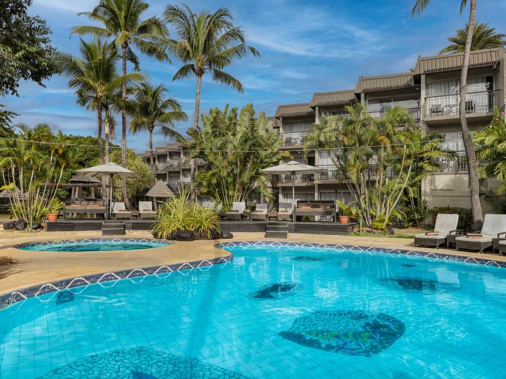 Novotel Nadi resort pool surrounded by palm trees and tropical gardens